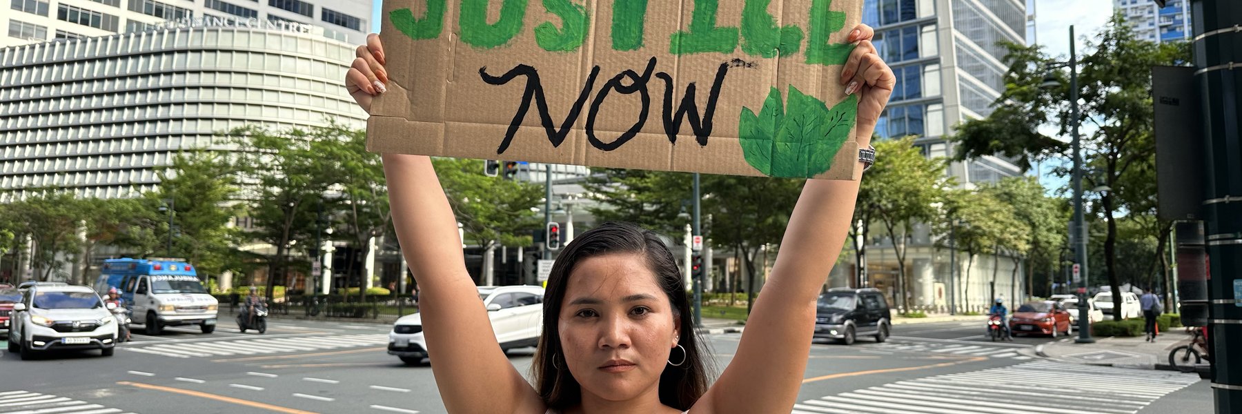 Marinel holding up her climate justice placard