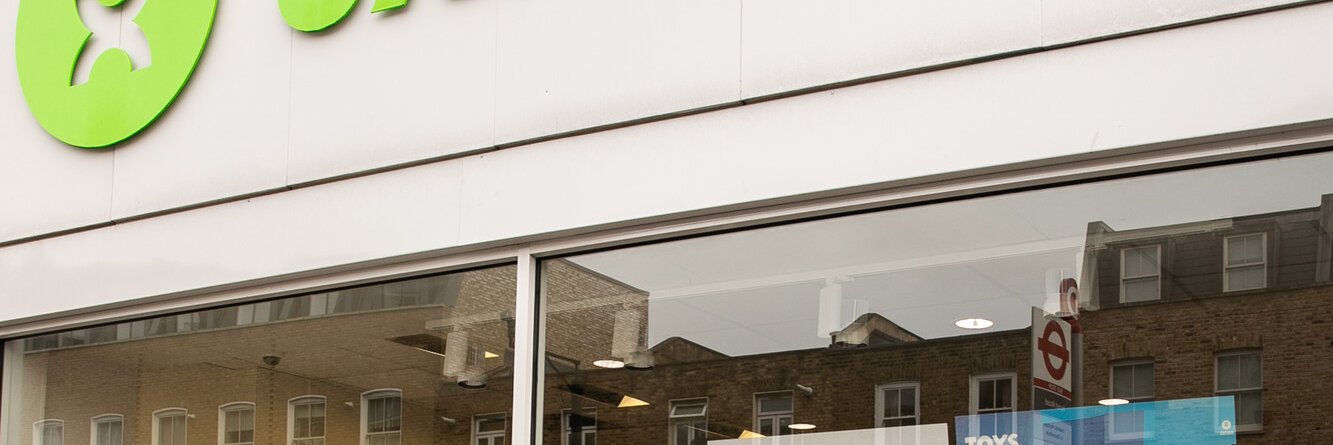 An exterior shot of the Oxfam shop in Dalston, featuring a large selection of donated books in the window display.