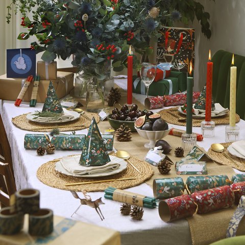 Table laid for a festive meal - candles and crackers