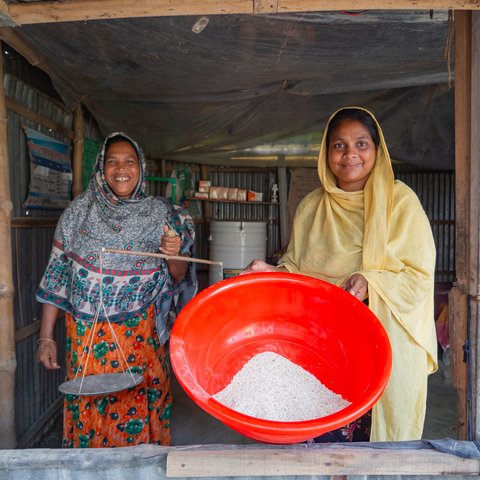 Alifa Begum and Lavly Akter at the store in Bangladesh where they sell fodder, supplements, and medicines for cows.