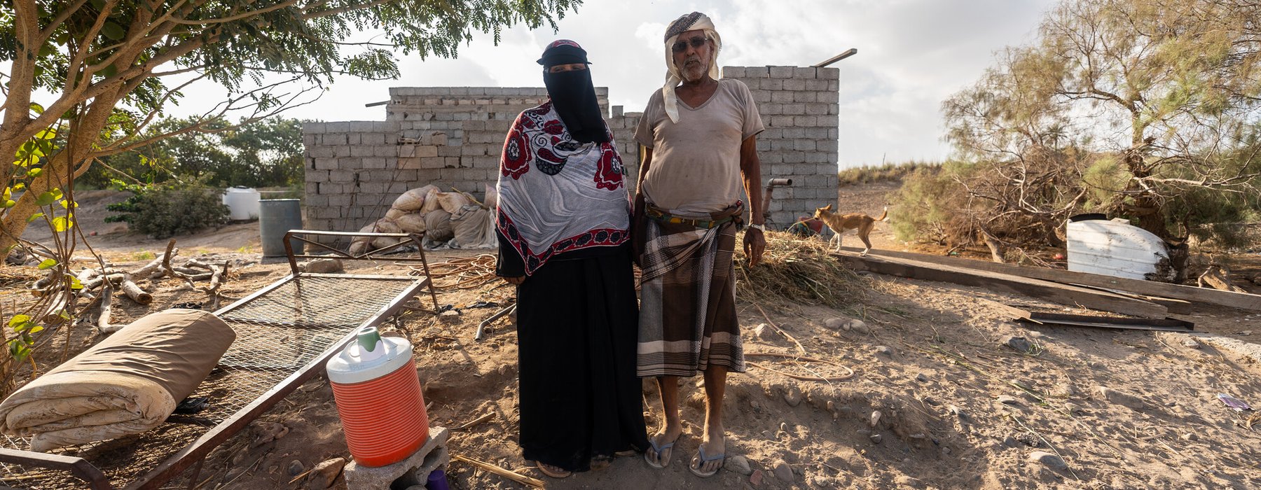 Arwa Ali Nabit, a 50-year-old farmer, and her husband, Hamid Mahmoud Abdullah, stand together in Al-Khaddad area in Lahj Governorate, Yemen.