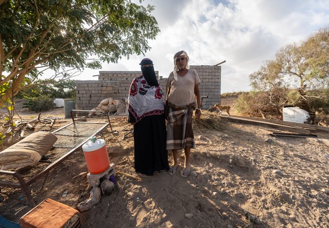 Arwa Ali Nabit, a 50-year-old farmer, and her husband, Hamid Mahmoud Abdullah, stand together in Al-Khaddad area in Lahj Governorate, Yemen.