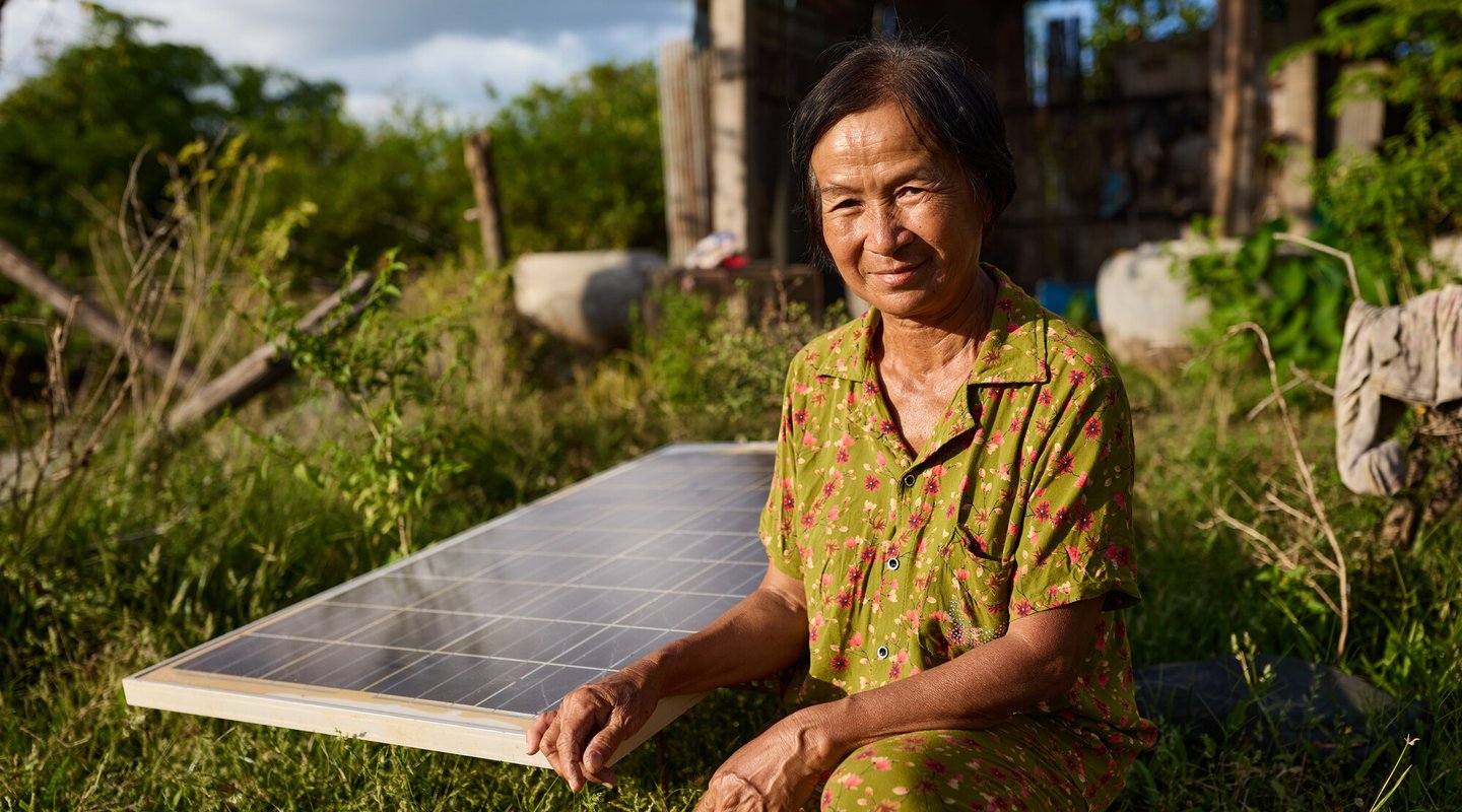 Vantha with the solar panels which help her power her greenhouse