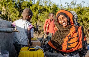 Seadiya Mohamed from Tigray fetches water closer to her home after Oxfam supported the construction of water point in Tigray, Ethiopia.