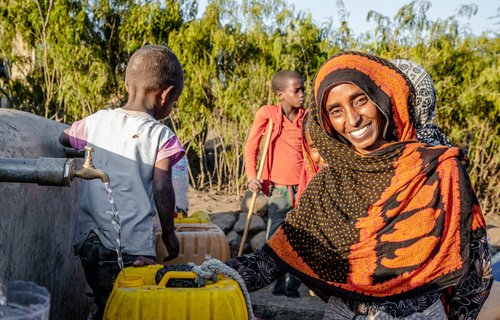 Seadiya Mohamed from Tigray fetches water closer to her home after Oxfam supported the construction of water point in Tigray, Ethiopia.