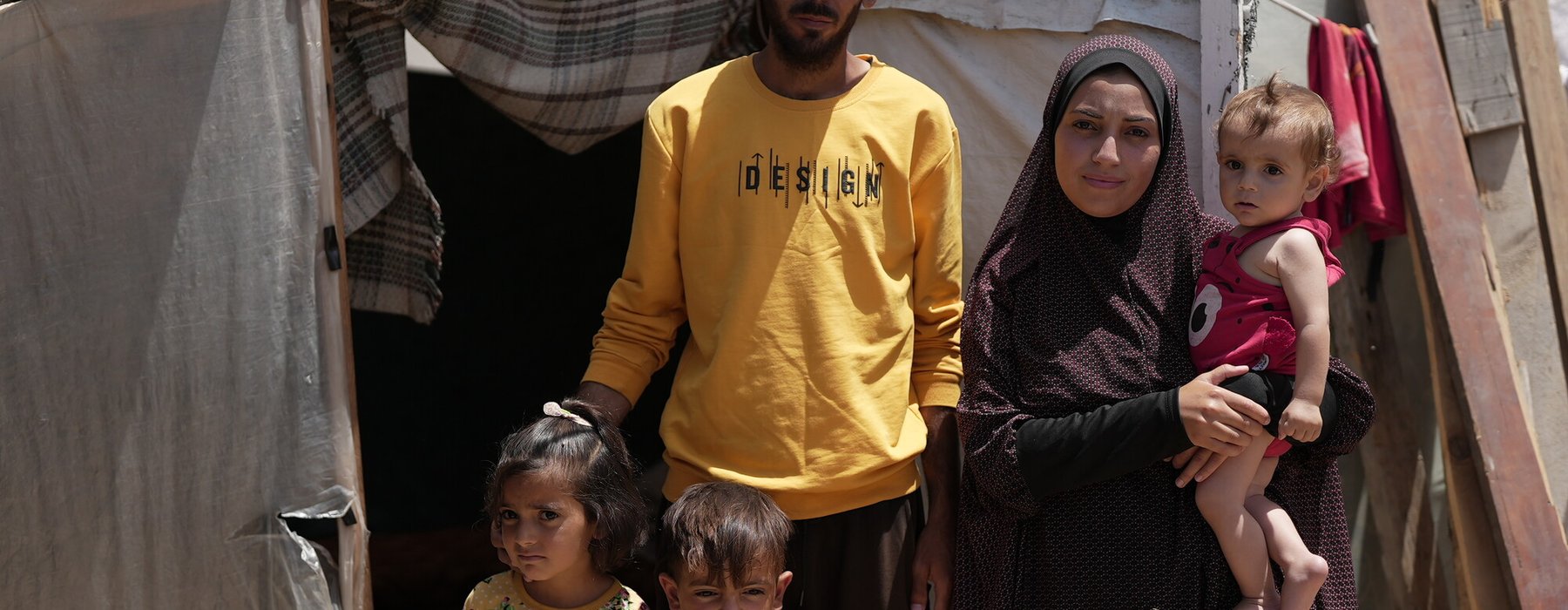 Duaa Abu Sabha is standing in front of her tent in the Al-Mawasi Area in Khan Yunis Governorate, Occupied Palestinian Territory.