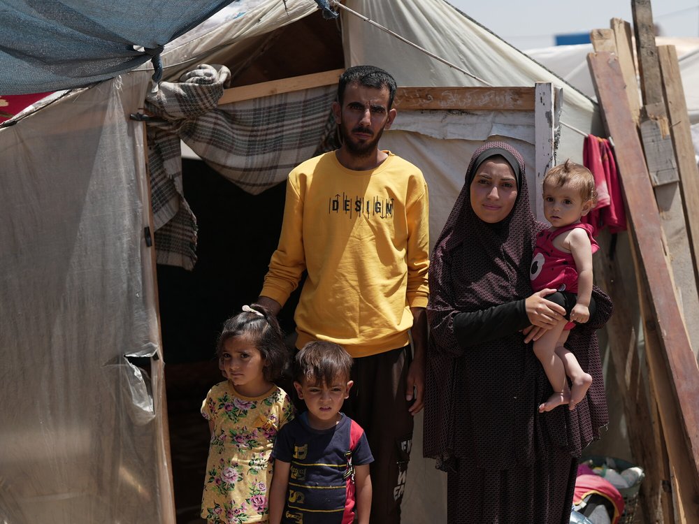 Duaa Abu Sabha is standing in front of her tent in the Al-Mawasi Area in Khan Yunis Governorate, Occupied Palestinian Territory.