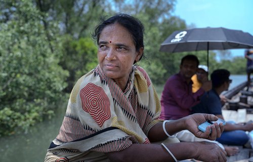 A woman sitting in a boat looking over her right shoulder