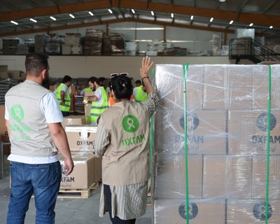 The Palestinian Agricultural Relief Committee loading and packing a shipment of dry food parcels from Oxfam to be shipped into Gaza.