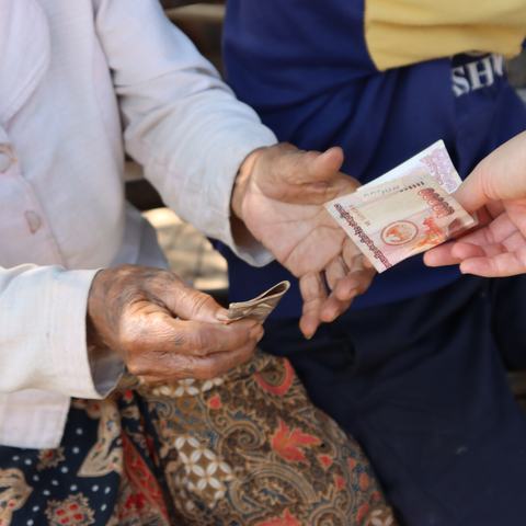 Mrs. Sa in Laos receives an Oxfam cash transfer.