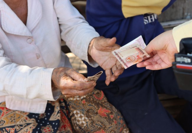 Mrs. Sa in Laos receives an Oxfam cash transfer.