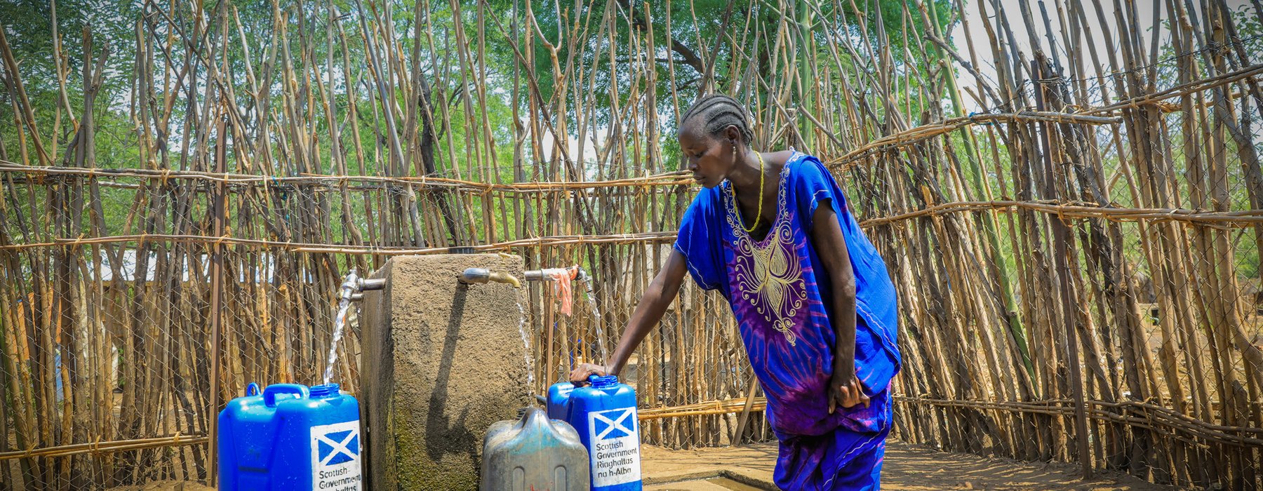 In the Pinyudo refugee camp in Gambella, Adugk, a south sudanese refugee, is pumping clean water in one of Oxfam's water installations.