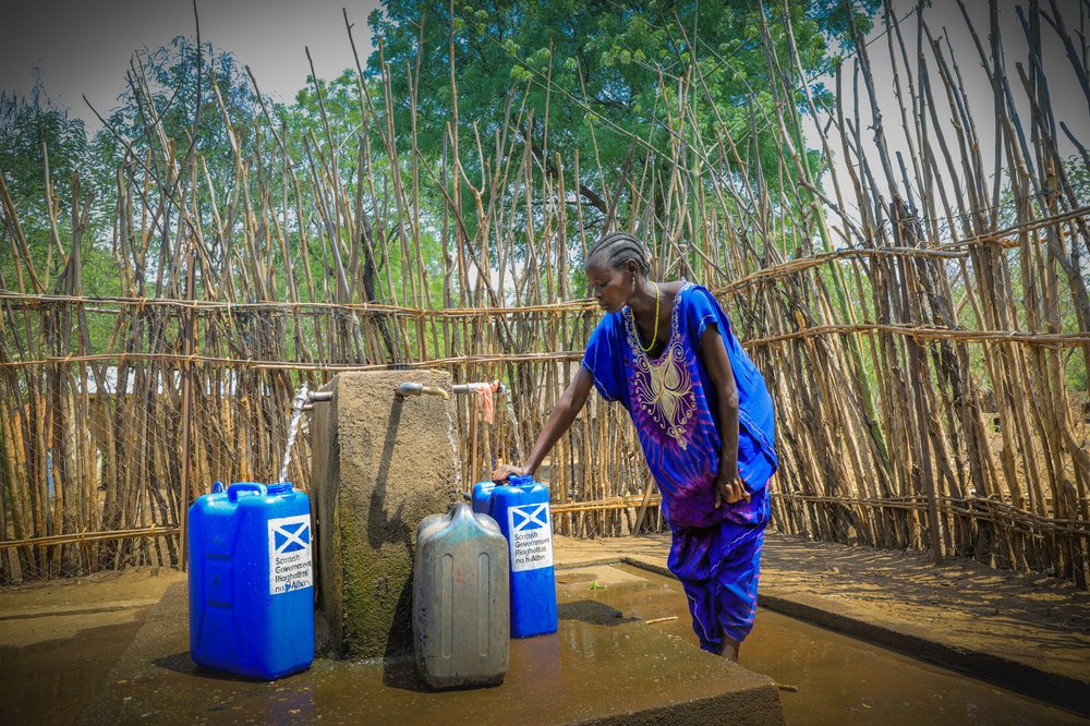 In the Pinyudo refugee camp in Gambella, Adugk, a south sudanese refugee, is pumping clean water in one of Oxfam's water installations.