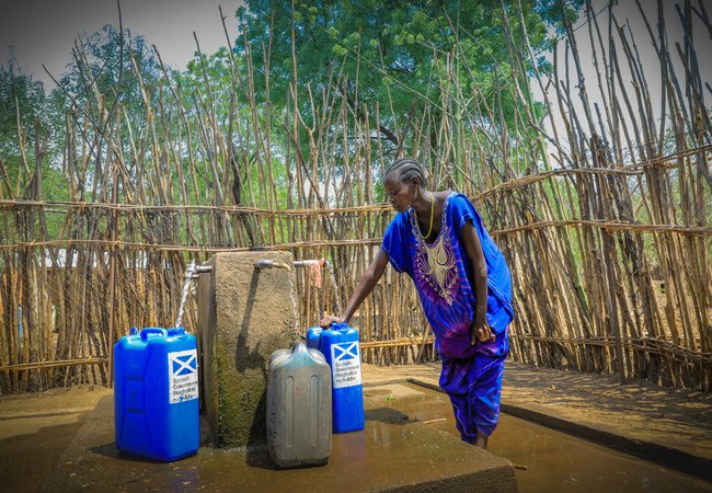 In the Pinyudo refugee camp in Gambella, Adugk, a south sudanese refugee, is pumping clean water in one of Oxfam's water installations.