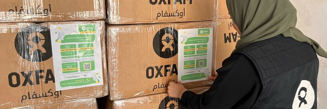 An Oxfam staff member preparing food parcels to be distributed in North Gaza.