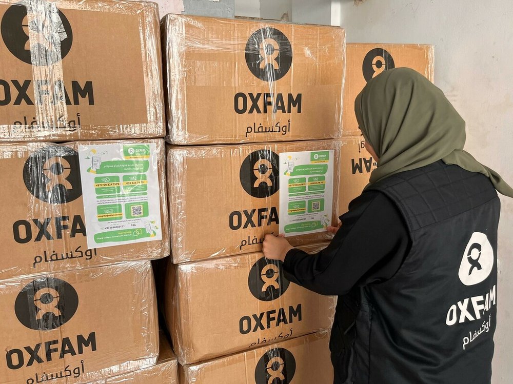 An Oxfam staff member preparing food parcels to be distributed in North Gaza.