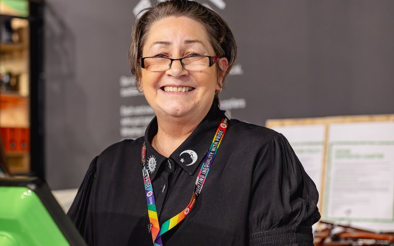 Jane smiles while serving at till at Manchester Superstore.
