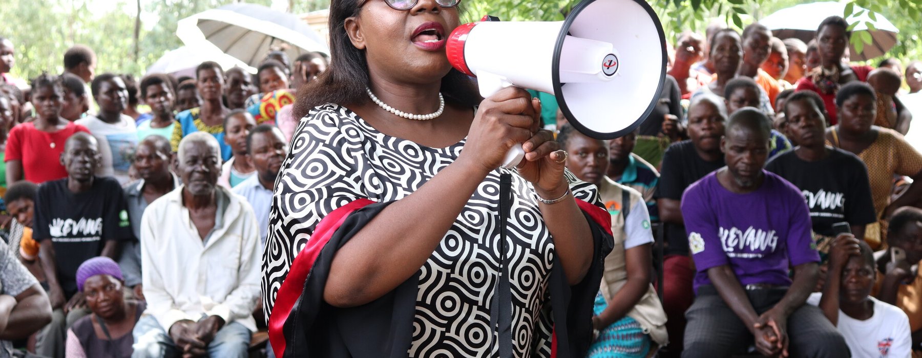 Lingalireni Mihowa stands with a megaphone and addresses a crowd