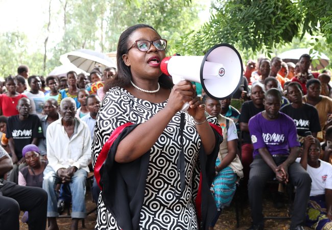 Lingalireni Mihowa stands with a megaphone and addresses a crowd