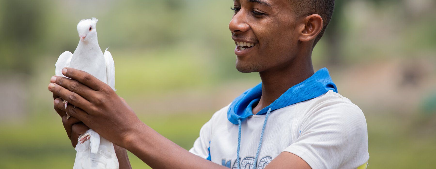 Munadhel holds one of the pigeons his family breeds.