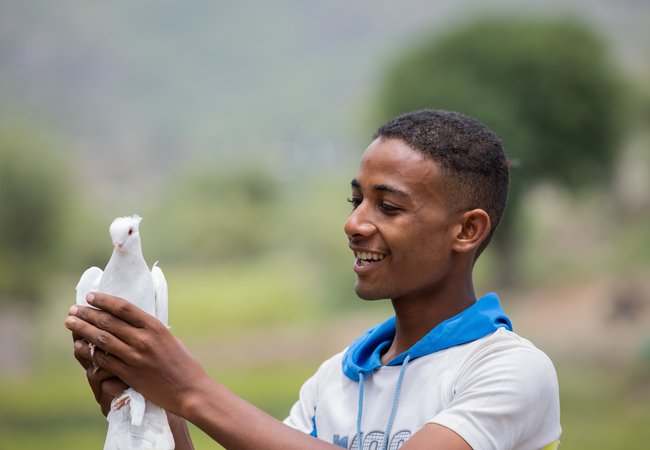 Munadhel holds one of the pigeons his family breeds.