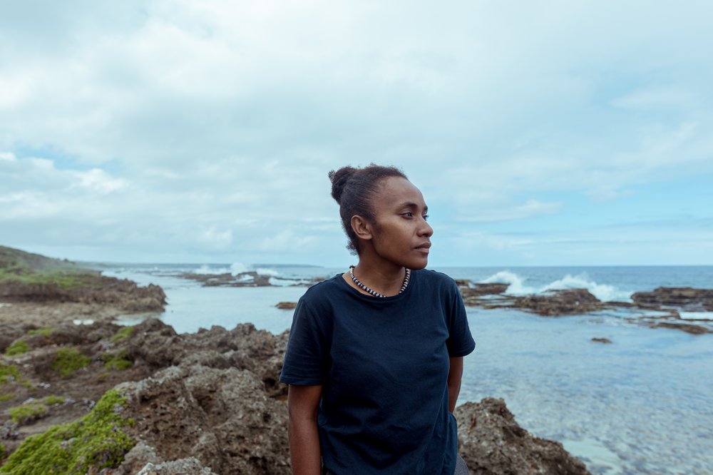 Cynthia standing on a rock looking out to sea