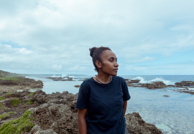 Cynthia standing on a rock looking out to sea