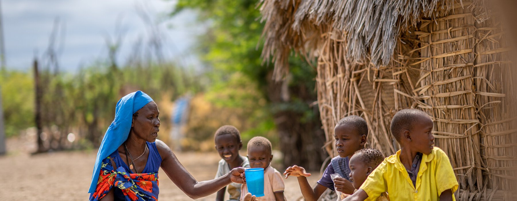 Margaret Ekamai feeding her children at home in Narengewoi, Turkana.