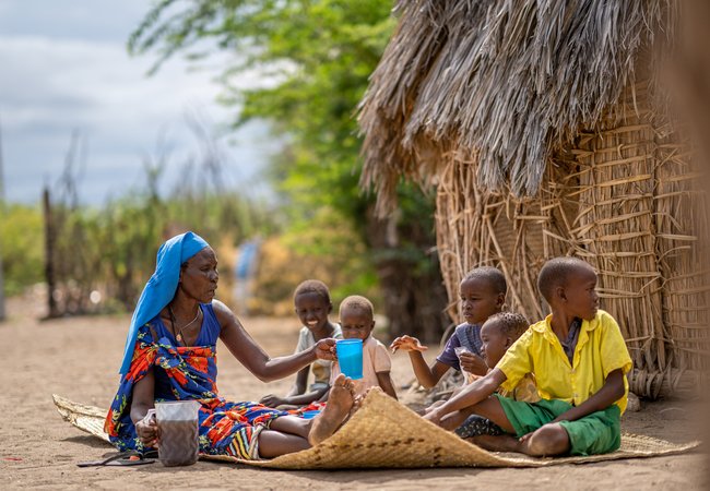 Margaret Ekamai feeding her children at home in Narengewoi, Turkana.