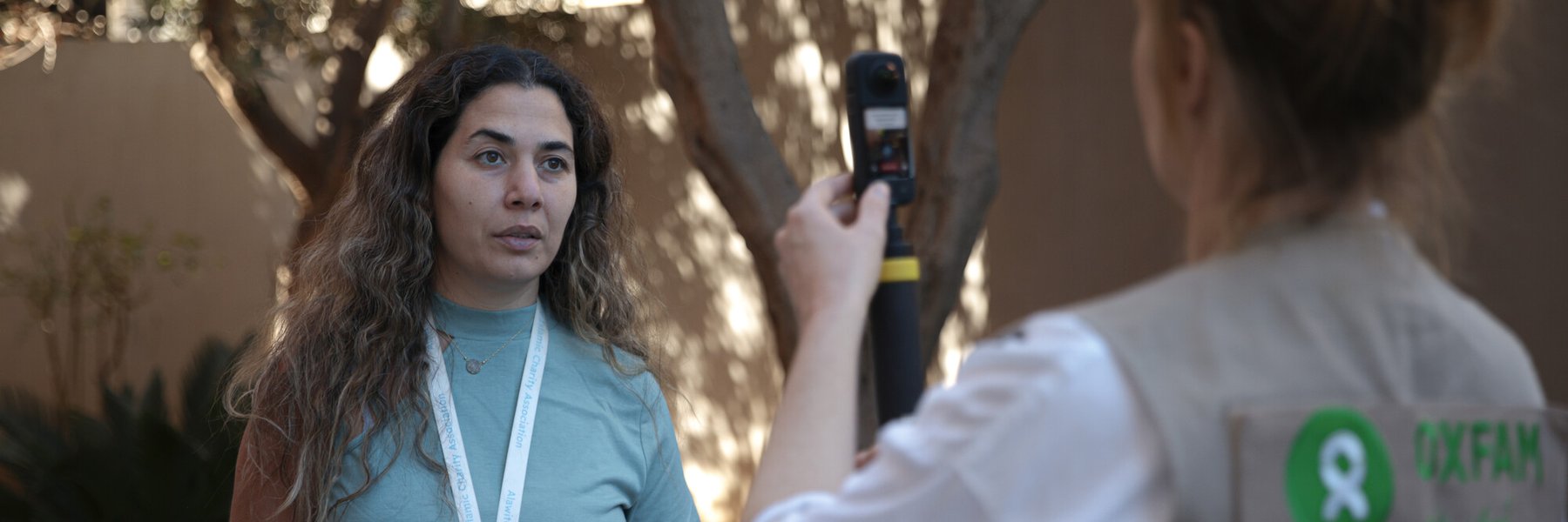 A member of Oxfam staff interviewing staff from Alawite Islamic Charity Association (AICA) in Lebanon.