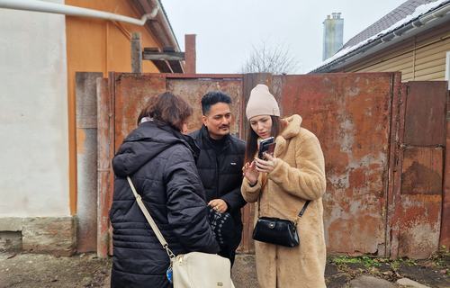 Anna Kulyeva, founder of the Charitable Foundation “Anika” in Ukraine, showing photos on her mobile phone.
