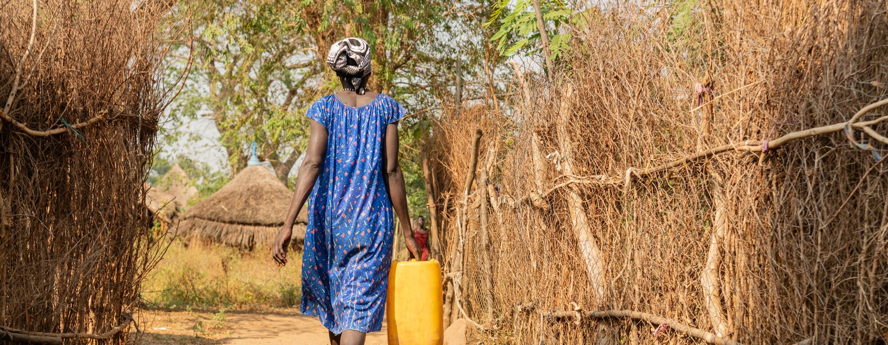 Myhtuk Hukuch, 34, walks to fetch water from a water point in Kule South Sudanese refugee camp, Gambella.