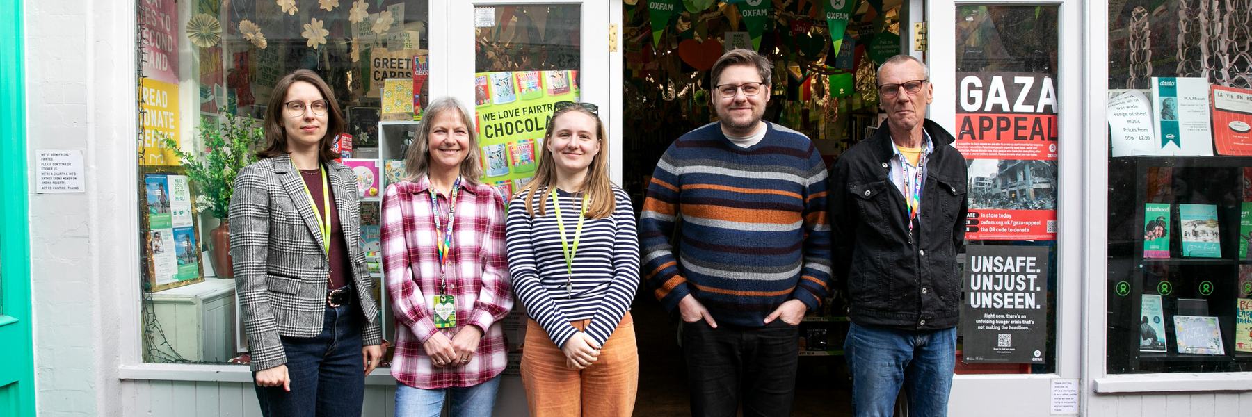 A group of volunteers stand outside the Oxfam bookshop in Brighton.