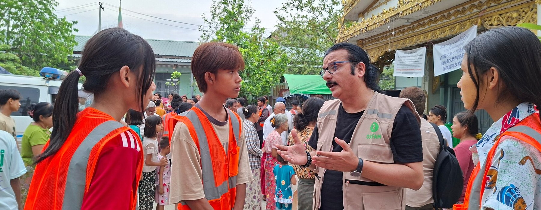 Oxfam country Director Rajan Khosla talking with young volunteers in Mandaley, Myanmar