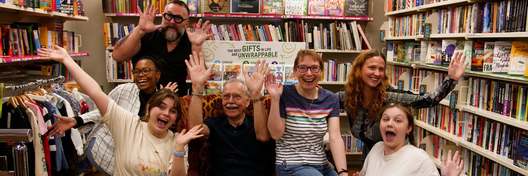 Group photo of volunteers smiling and waving.