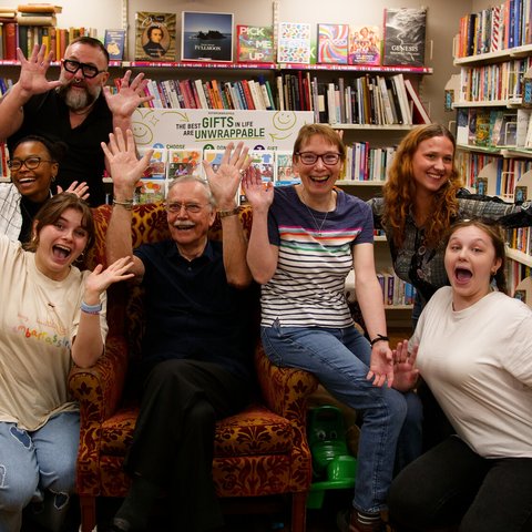 Group photo of volunteers smiling and waving.