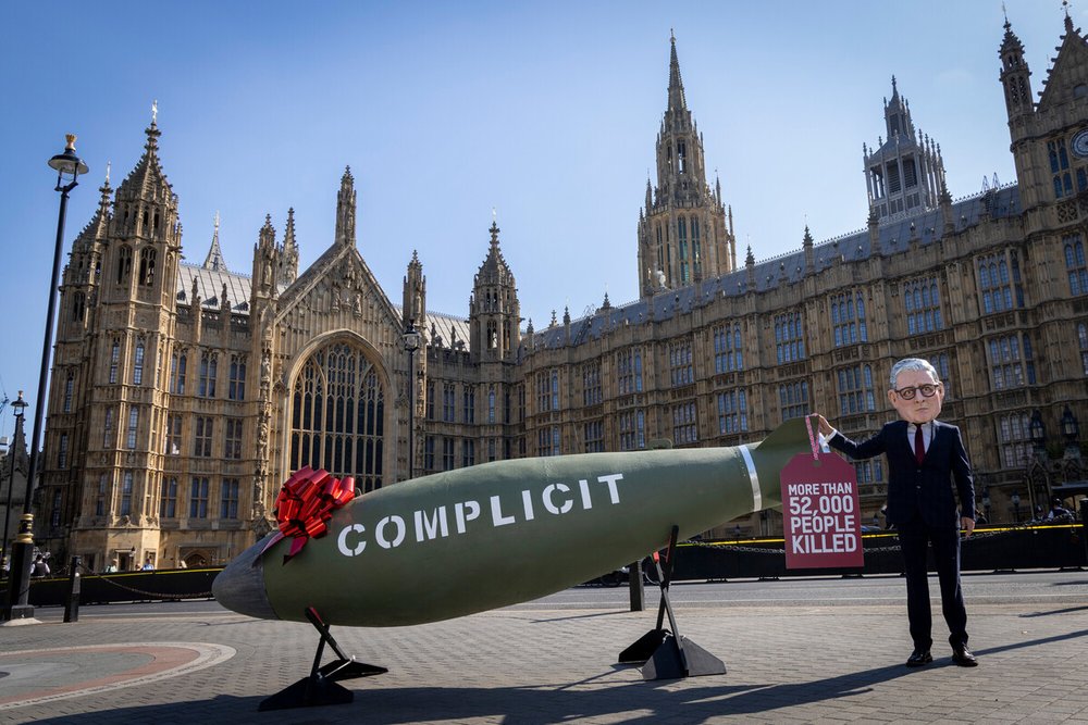 Oxfam’s ‘Keir Starmer’ Big Head appeared outside the UK Parliament with a 16-foot replica MK-84 bomb.
