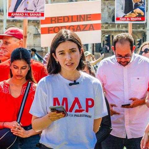 Marnie Lekutanoy from Medical Aid for Palestinians speaks at a protest outside Westminster in July 2025.