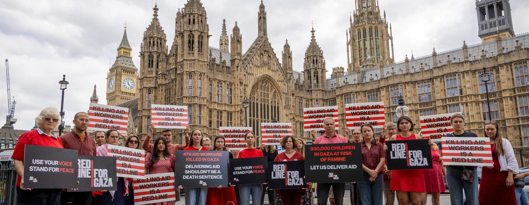 Campaigners hold placards during Red Line for Gaza action in Westminster.