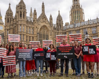 Campaigners hold placards during Red Line for Gaza action in Westminster.