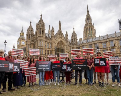 Campaigners hold placards during Red Line for Gaza action in Westminster.