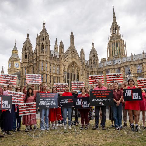 Campaigners hold placards during Red Line for Gaza action in Westminster.