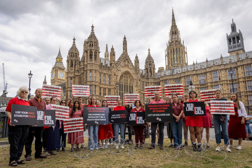 Campaigners hold placards during Red Line for Gaza action in Westminster.