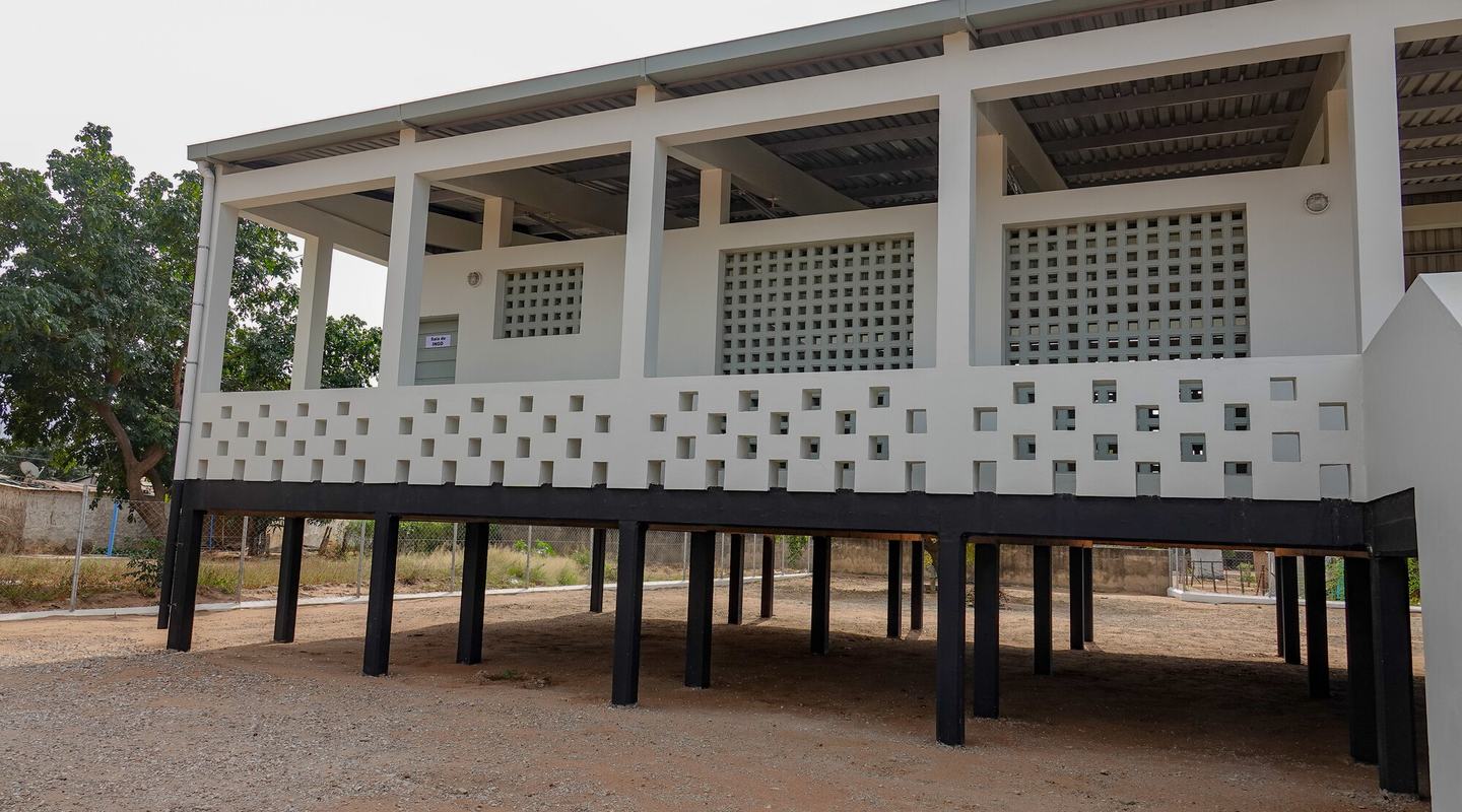 A sturdy white building built on strong struts, designed to shelter the most vulnerable during floods