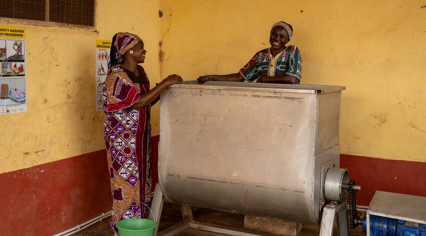 Safura and Ainabu laugh while milling shea nuts at the Bunglung Suglo Mali Nyori Cooperative Shea Butter Producers centre in Bunglung, Northern Region of Ghana.