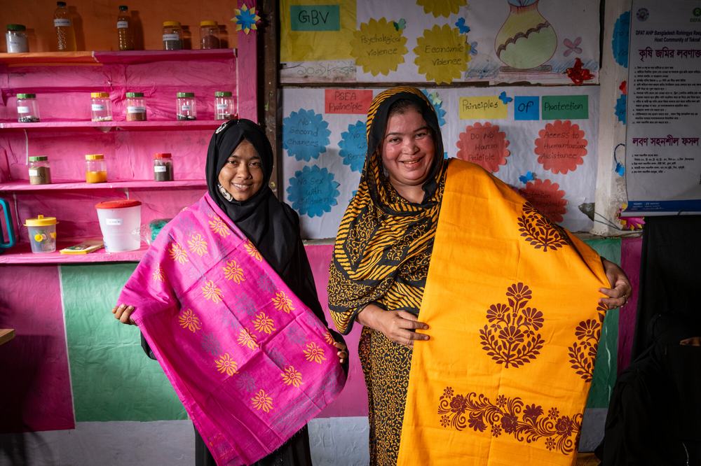 Sumaiya and Bulbul display one of their hand-stitched crafts at a woman-led multipurpose centre in Cox's Bazar, Bangladesh.