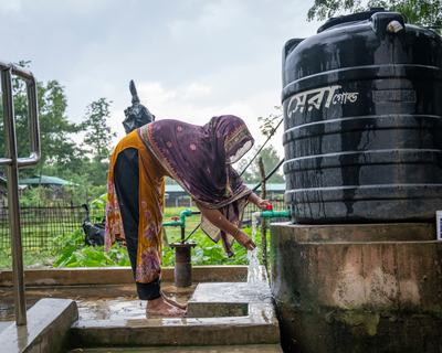 Monowara Begum, 30, from North Ali Khali, Teknaf, collects water from an Oxfam-built tubewell tapstand.