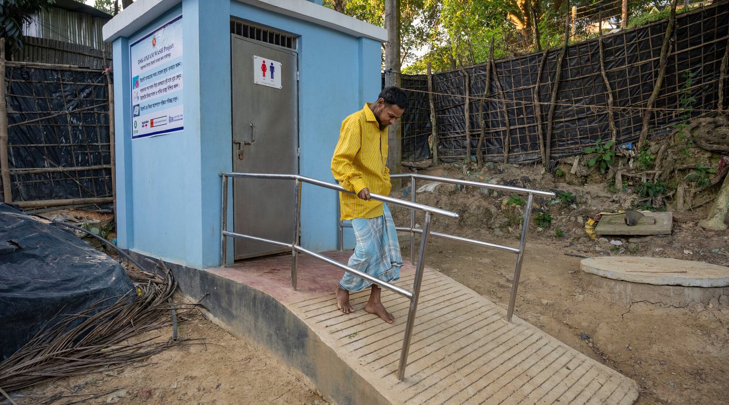 MD. Mustaq, 45, a man with a physical disability, uses ramp at a sanitation facility provided by Oxfam.