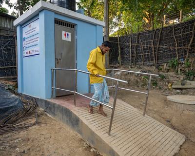 MD. Mustaq, 45, a man with a physical disability, uses ramp at a sanitation facility provided by Oxfam.