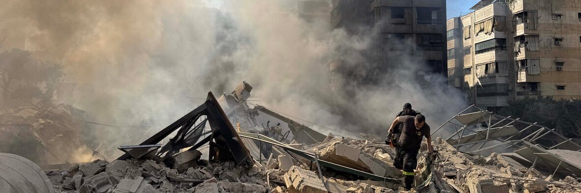 Rescue workers search through the rubble after Israel's overnight bombing of Beirut's southern suburbs.